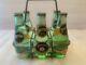 Rare/vintage Perrier Metal Carrier & 5 6.5 Fl Oz Sealed Pry Off Cap Bottles